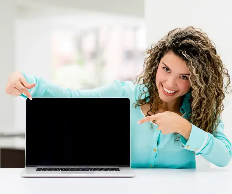 Happy Nurse Coach pointing to her Sacred Virtual Space computer screen