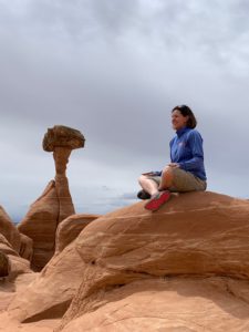 woman sitting on red mountain in peace and calm